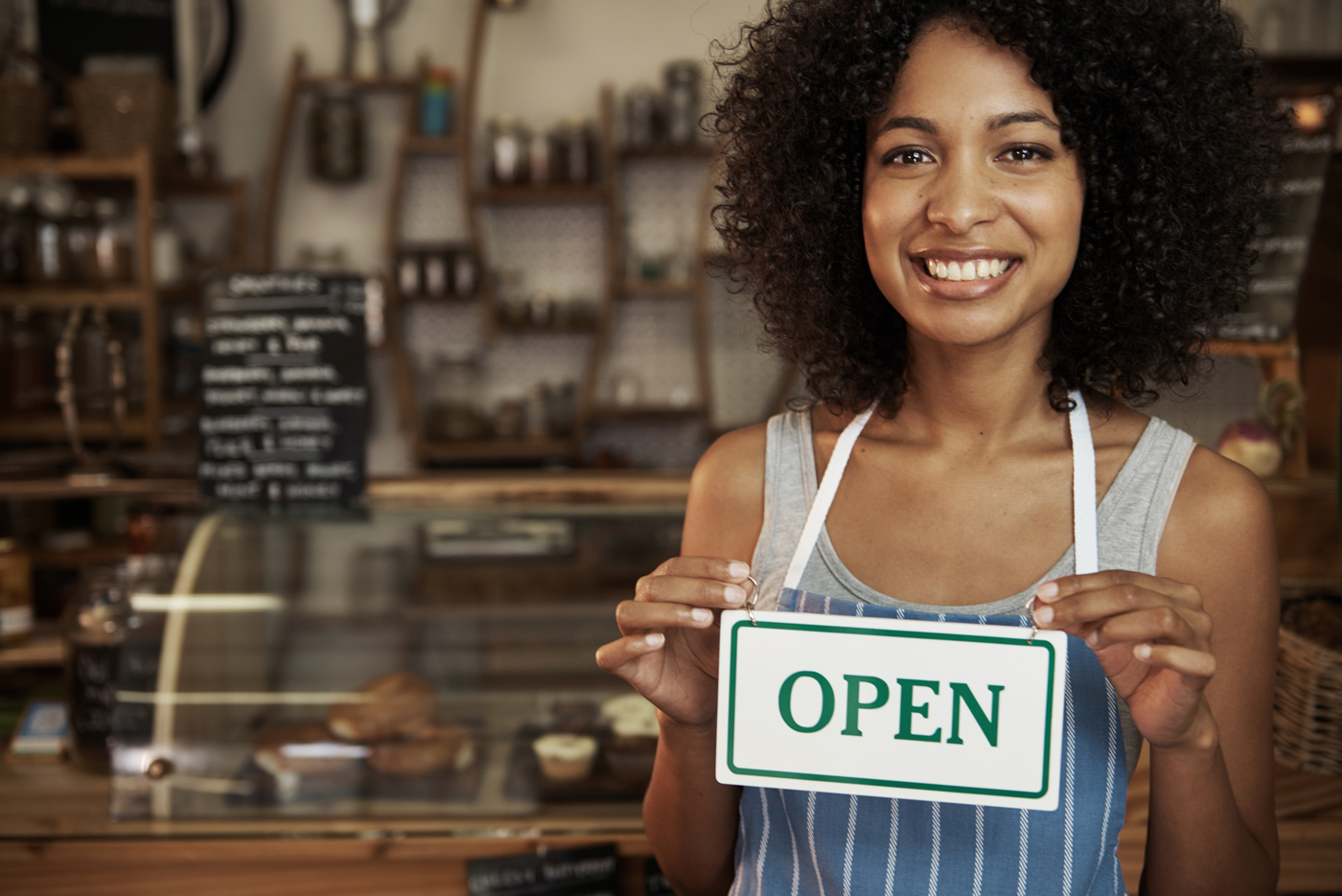 woman-holding-open-sign woman-holding-open-sign